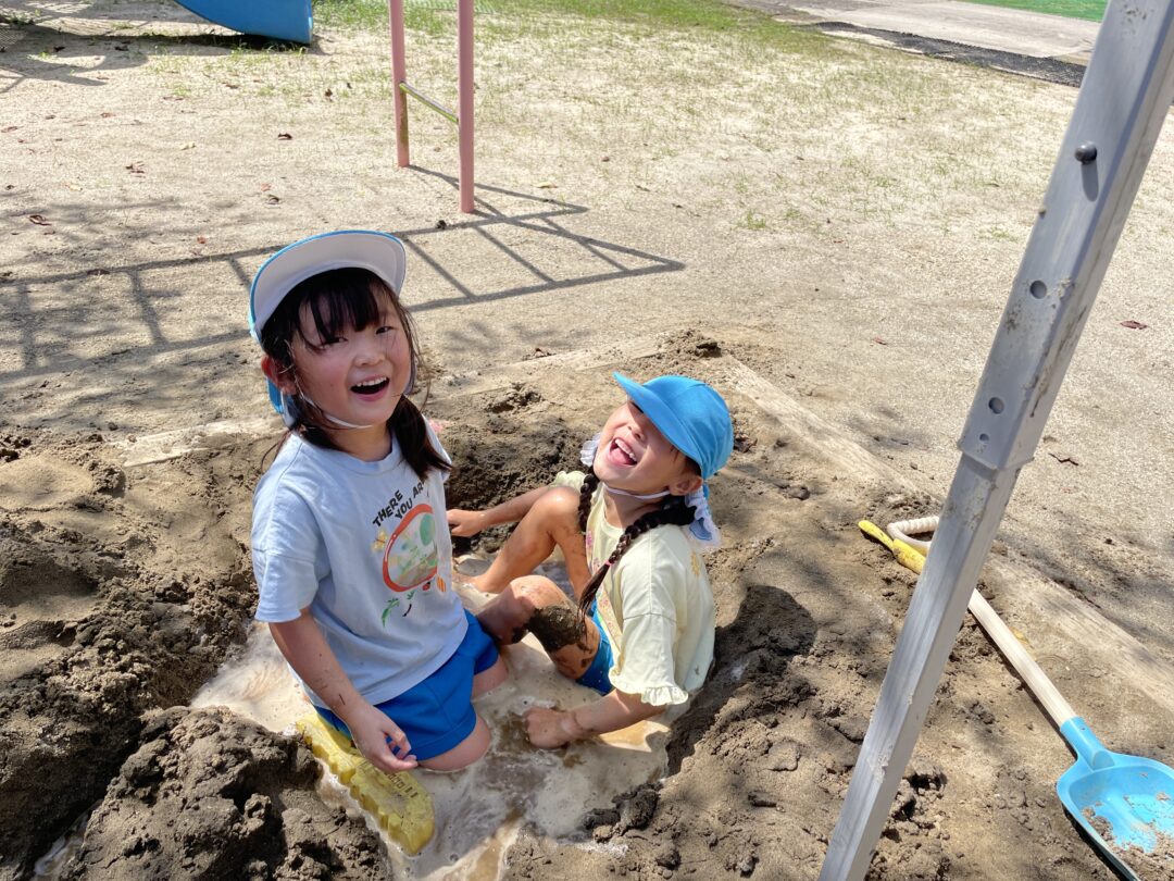 土や砂、水で遊ぶ園児